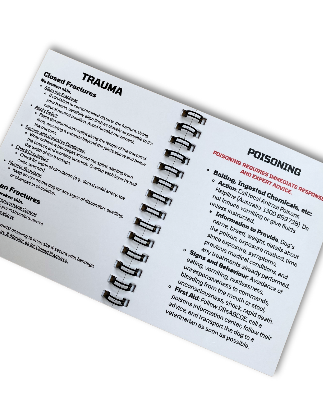 Open dog first aid book showing management trauma and poisoning.