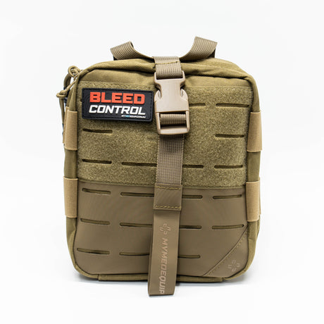 Tan Brown Trauma Kit sitting on white backgound. Pouch has lasercut molle and a velcro front panel with a large grey PVC patch showing contours and large red and white text stating: Bleed Control
