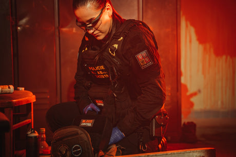 Female Police Officer in atmospheric dark red environment Handling Large Team IFAK