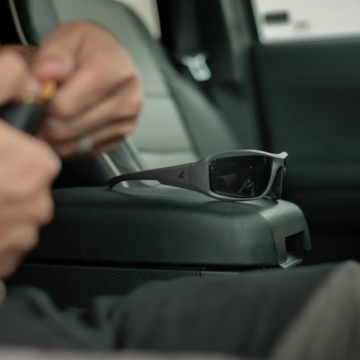 Ballistic sunglasses on centre console of car