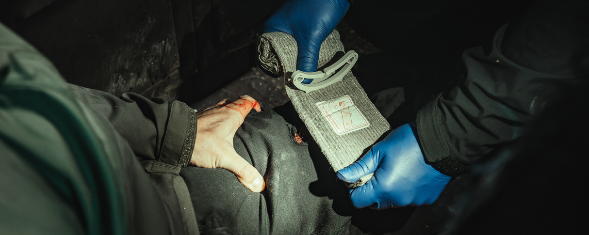 Green Israeli Bandage being applied to injured leg