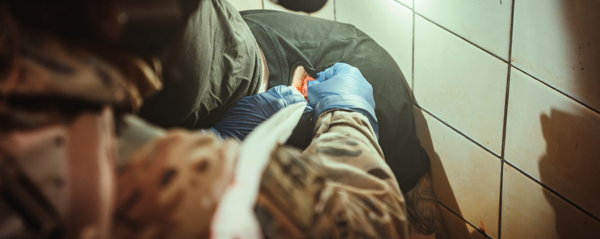 Soldier packing junctional chest/axillary wound