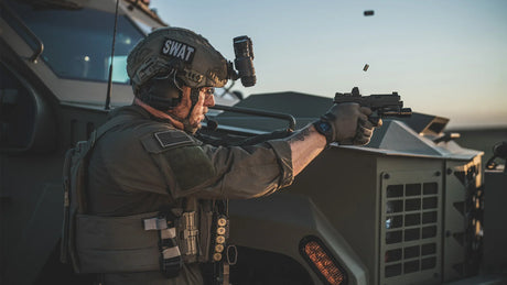Soldier firing handgun wearing helmet & Ballistic Glasses Eyewear