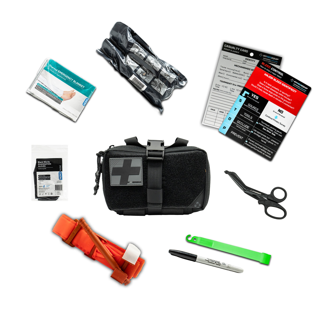 A Black Coloured IFAK (Individual First Aid Kit) pouch with a black and grey PVC cross on it. Around the IFAK are laid out it's contents which include, gloves, a Combat Application Tourniquet, trauma shears, glow stick, sharpie marker pen. Bleed Control Instructional Card, a casualty card, a thermal blanket and a 4" trauma pressure bandage.