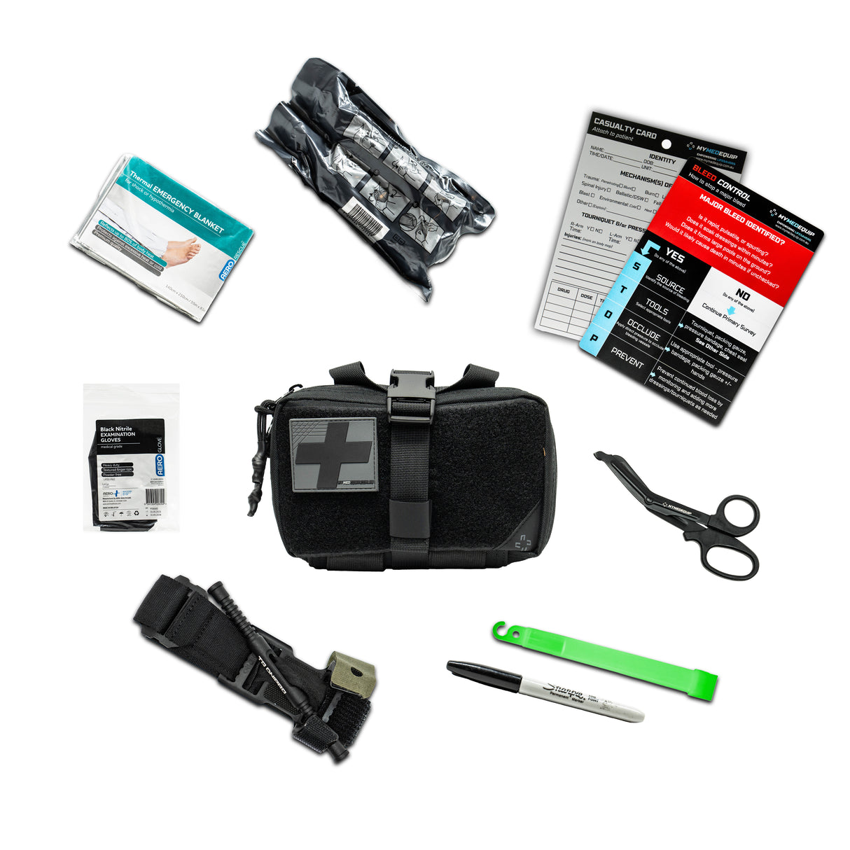 A Black Coloured IFAK (Individual First Aid Kit) pouch with a black and grey PVC cross on it. Around the IFAK are laid out it's contents which include, gloves, a DNIPRO Tourniquet, trauma shears, glow stick, sharpie marker pen. Bleed Control Instructional Card, a casualty card, a thermal blanket and a 4" trauma pressure bandage.