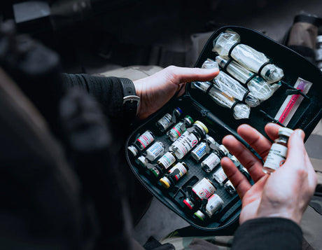 Medic handling a drug case with vials and injection equipment