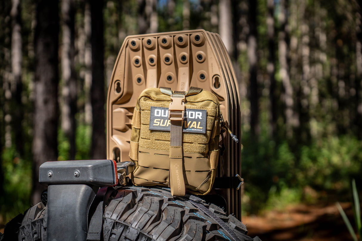 Tan Brown Survival Kit infront of 4wd accessories maxtrax in Australian bushland with Molle / PALS webbing, velcro patch 