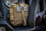 Tan coloured outdoor survival kit sitting on bulbar of car. Survival kit is strapped together and has laser cut molle front panel.