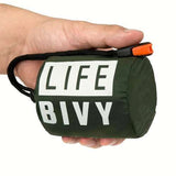 Bright orange Bivouac emergency survival bag packed in green drawstring pouch