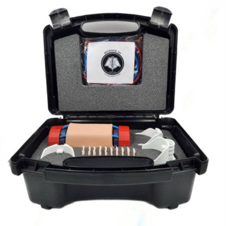 An open black hard carrying case containing a medical training kit with foam padding, a beige practice device, red end caps, white splinting material, and a small booklet inside.